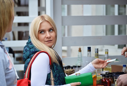 Happy female customer paying retail store